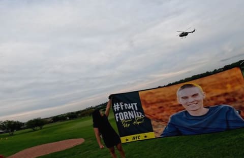 Runners gathered behind the fun run banner